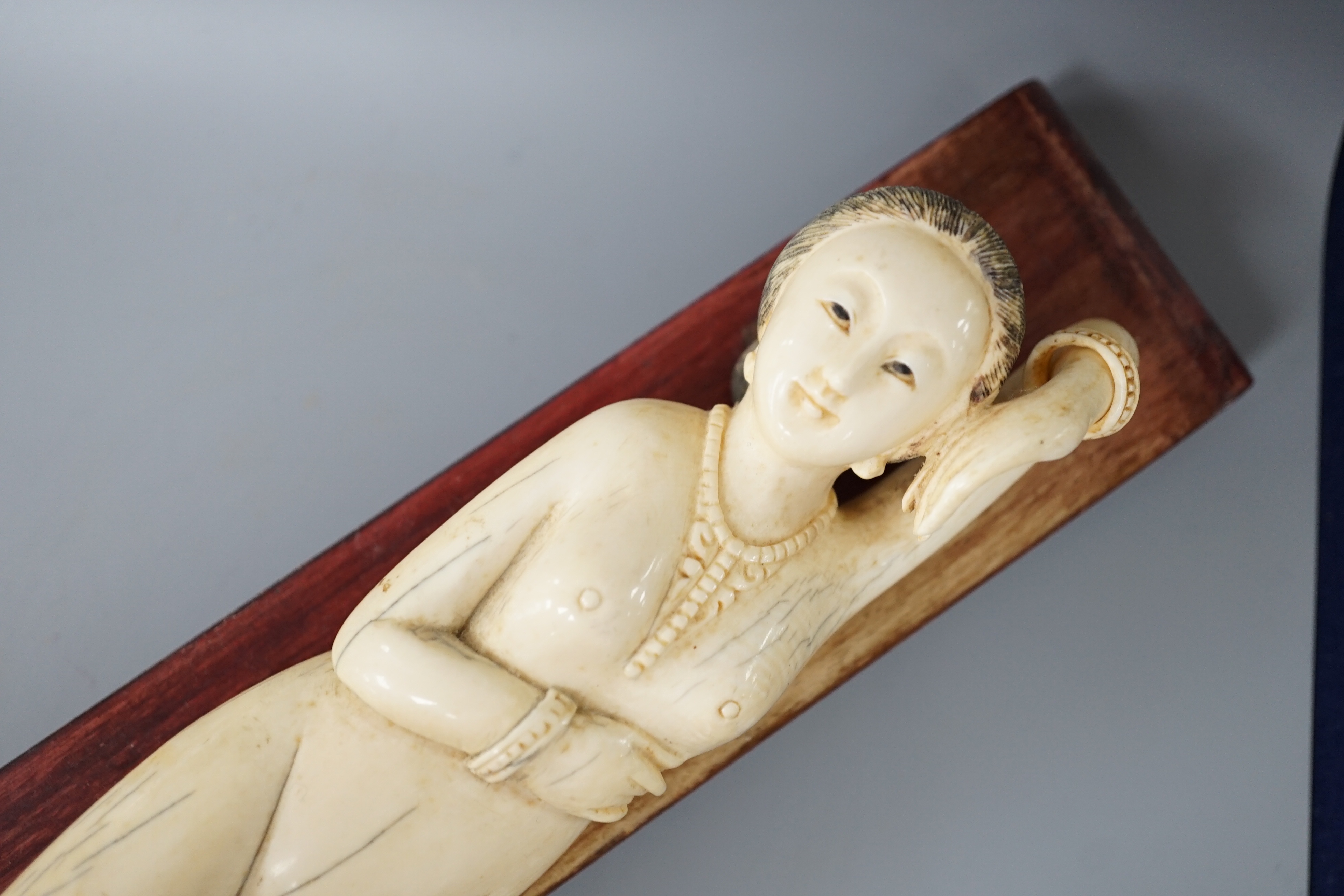 A Chinese carved ivory medicine figure, late 19th/early 20th century, wood stand. 25cm excl stand